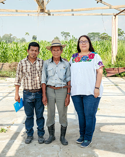 Paula Barrios stands with two community members. Photo: UN Women/Ryan Brown