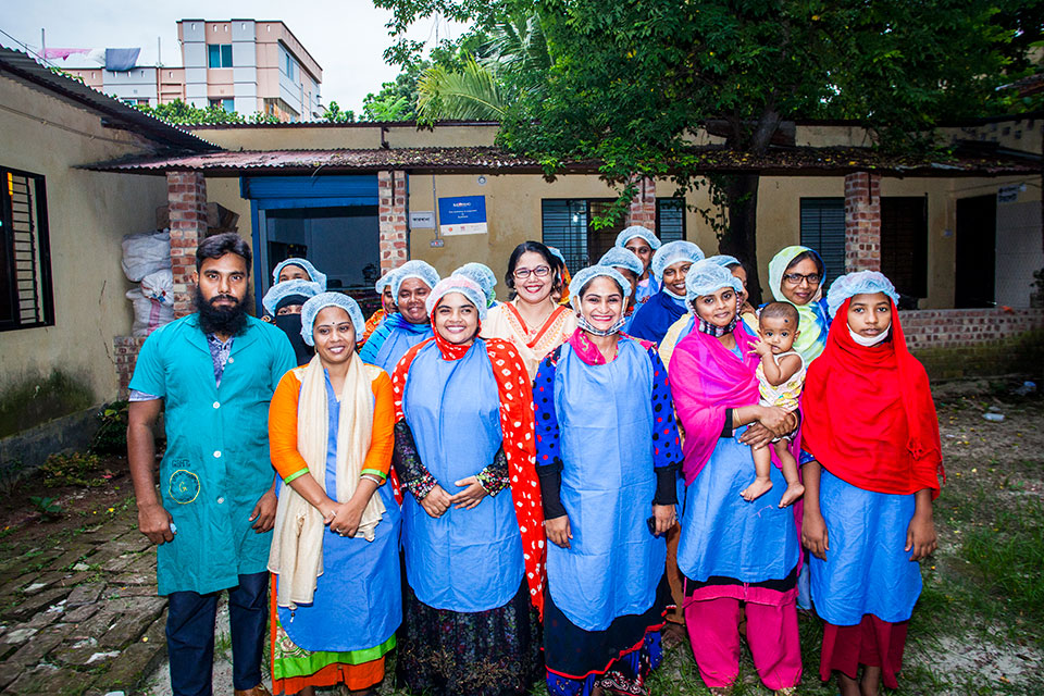 Parveen Akter (center) with workers. Photo: UN Women/Fahad Kaizer