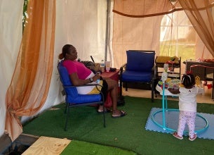 A mother and her child utilize the nursing nook at the Ti Vilaj Kweyol Festival. UN Women Photo