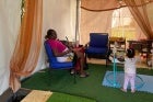 A mother and her child utilize the nursing nook at the Ti Vilaj Kweyol Festival. UN Women Photo